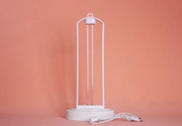 Ultraviolet lamp on peach background. Air sterilization
