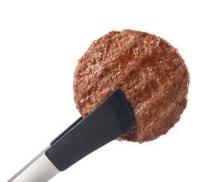 Tongs with tasty grilled hamburger patty on white background