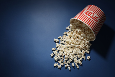 Delicious popcorn on blue background, top view. Space for text