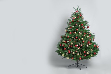 Beautifully decorated Christmas tree on white background