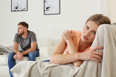 Young couple ignoring each other after argument in living room. Relationship problems