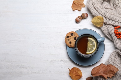 Flat lay composition with hot drink on white wooden background, space for text. Cozy autumn
