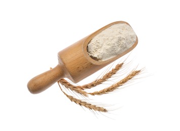 Flour in scoop and spikelets on white background, top view