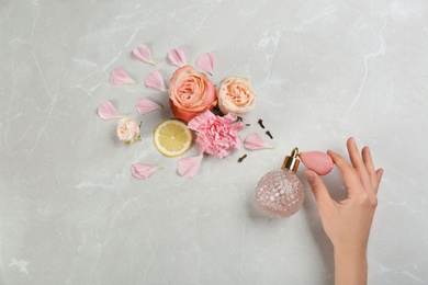 Woman with perfume. Fragrance composition, flowers and lemon on marble background,  top view