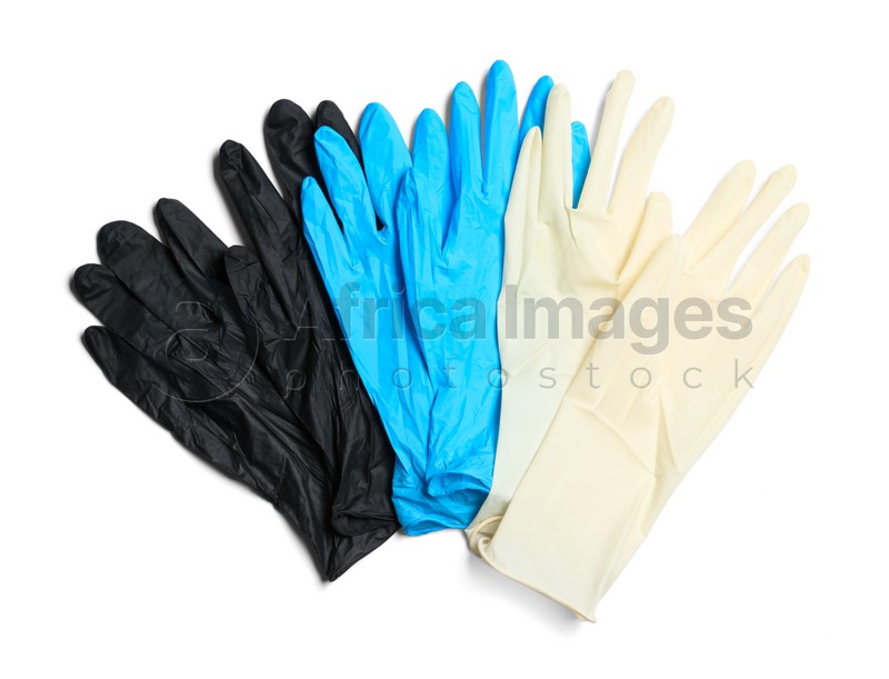 Different medical gloves on white background, top view