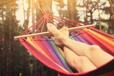 Woman resting in hammock outdoors on summer day, closeup