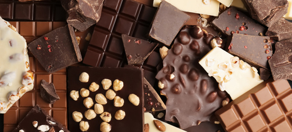 Many different delicious chocolate bars as background, top view. Banner design 