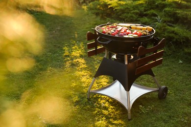 Photo of Delicious grilled vegetables on barbecue grill outdoors. Space for text