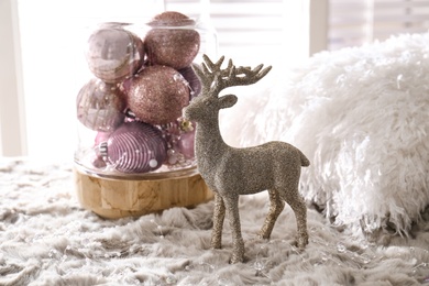 Beautiful pink Christmas baubles and deer on grey fur