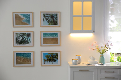 Stylish kitchen interior with beautiful artworks on wall