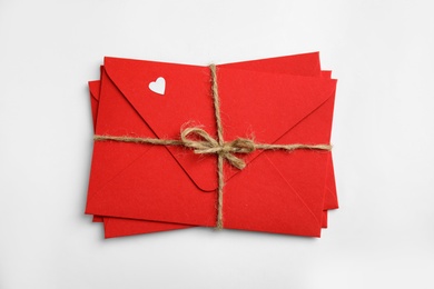 Stack of red envelopes on white background, top view. Love letters