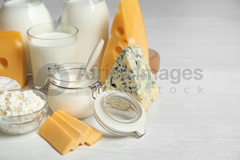 Different delicious dairy products on white table