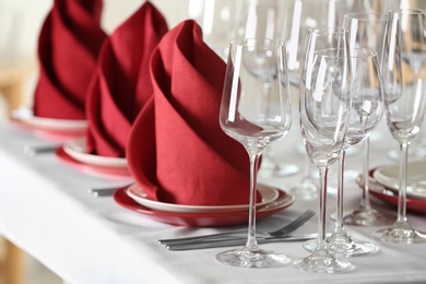 Table setting with empty glasses, plates and cutlery on table