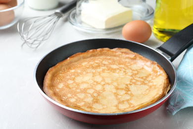 Delicious thin pancakes on grey marble table, closeup