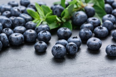 Tasty fresh blueberries on grey table, closeup