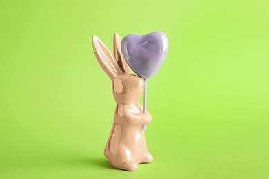 Bunny ceramic figure as Easter decor on green background