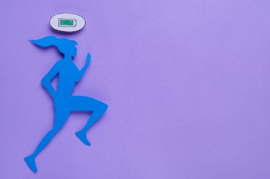 Photo of Woman`s health. Paper female figure running on lilac background, top view. Space for text