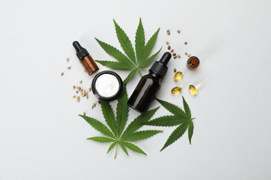 Flat lay composition with hemp leaves, CBD oil and THC tincture on light background