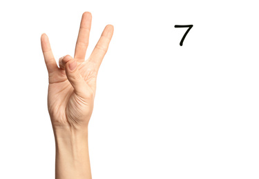 Image of Woman showing number seven on white background, closeup. Sign language