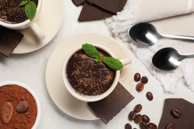 Delicious hot chocolate with fresh mint served on grey table, flat lay