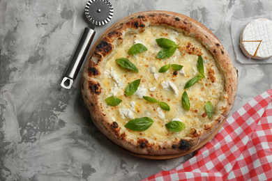 Photo of Delicious cheese pizza with basil on grey table, flat lay