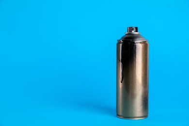Used can of spray paint on light blue background. Space for text