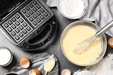 Photo of Flat lay composition with ingredients for cooking Belgian waffles on grey table