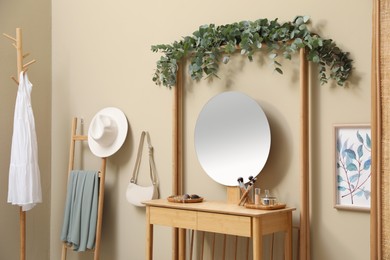 Stylish room decorated with beautiful eucalyptus garland on dressing table