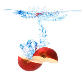 Cut apple falling down into clear water against white background