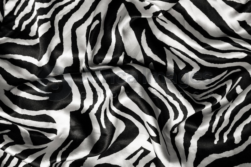 Photo of Texture of beautiful fabric with animal pattern as background, top view