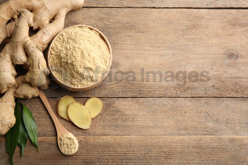 Fresh ginger root, powder and leaves on wooden table, flat lay. Space for text