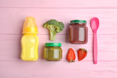 Flat lay composition with healthy baby food and ingredients on pink wooden table
