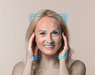Facial recognition system. Mature woman with scanner frame and digital biometric grid on light background