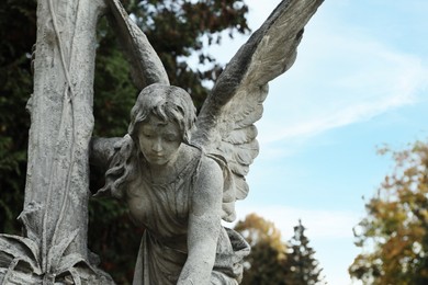 Beautiful statue of angel at cemetery, space for text. Funeral ceremony