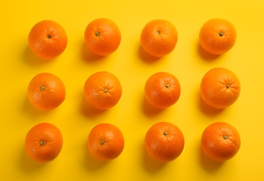 Fresh ripe oranges on yellow background, flat lay