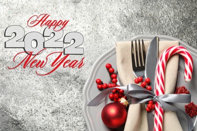 Happy New 2022 Year! Beautiful table setting on grey background, top view 