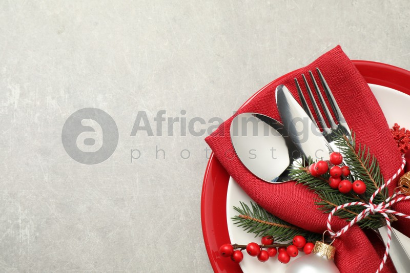 Beautiful Christmas table setting on light grey background, top view. Space for text