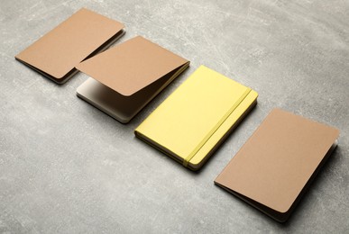 Yellow and brown planners on grey table