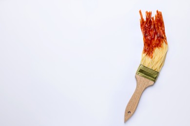 Brush painting with spaghetti dipped in ketchup on white background, top view. Space for text. Creative concept
