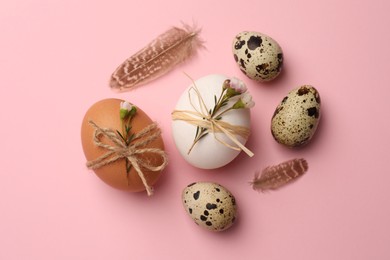 Photo of Festively decorated eggs on pink background, flat lay. Happy Easter