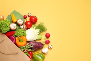 Photo of Different fresh vegetables on yellow background, flat lay. Space for text
