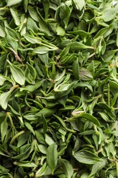 Pile of fresh green thyme leaves as background, top view
