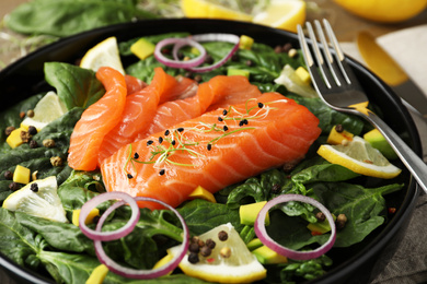 Delicious fresh salmon with spinach on plate, closeup