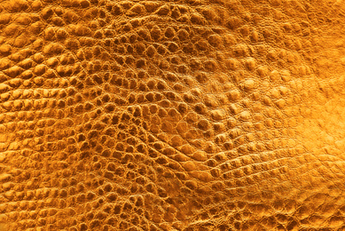 Texture of orange leather as background, closeup