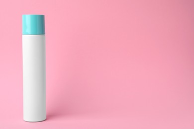 Photo of Bottle of dry shampoo on pink background. Space for text