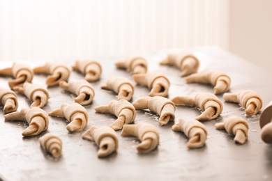 Raw croissants on grey table
