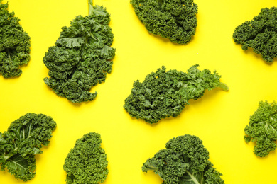 Fresh kale leaves on yellow background, flat lay
