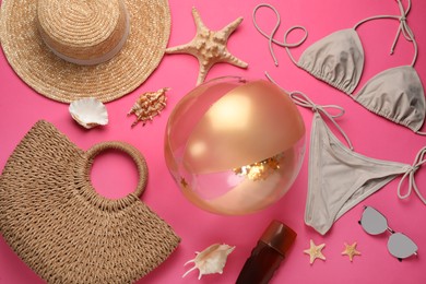 Photo of Flat lay composition with ball and beach objects on pink background