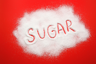 Photo of Composition with word SUGAR on red background, top view