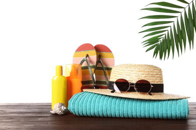 Photo of Composition with different beach objects on wooden table, white background